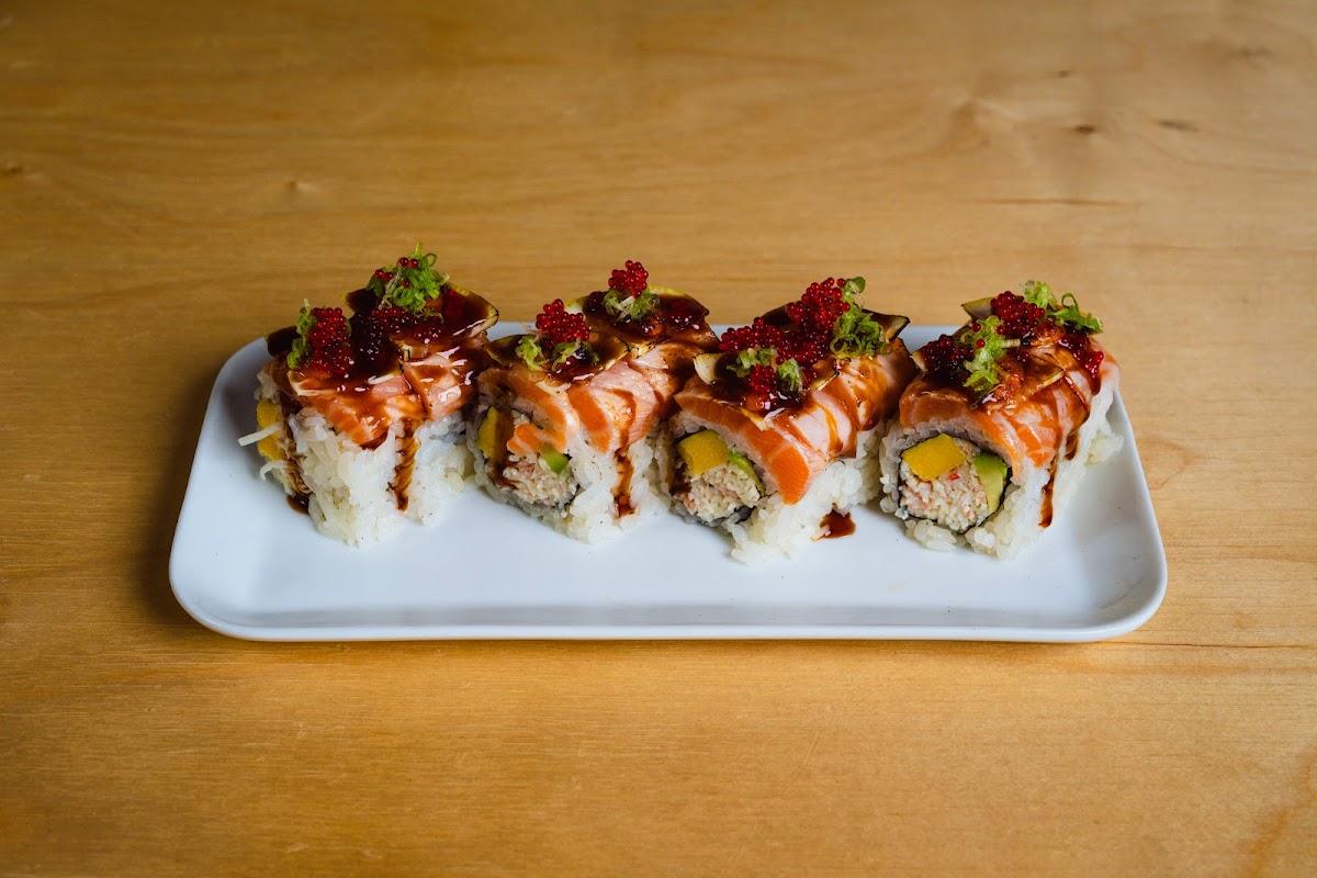 Yama roll topped with salmon, red tobiko and lemon